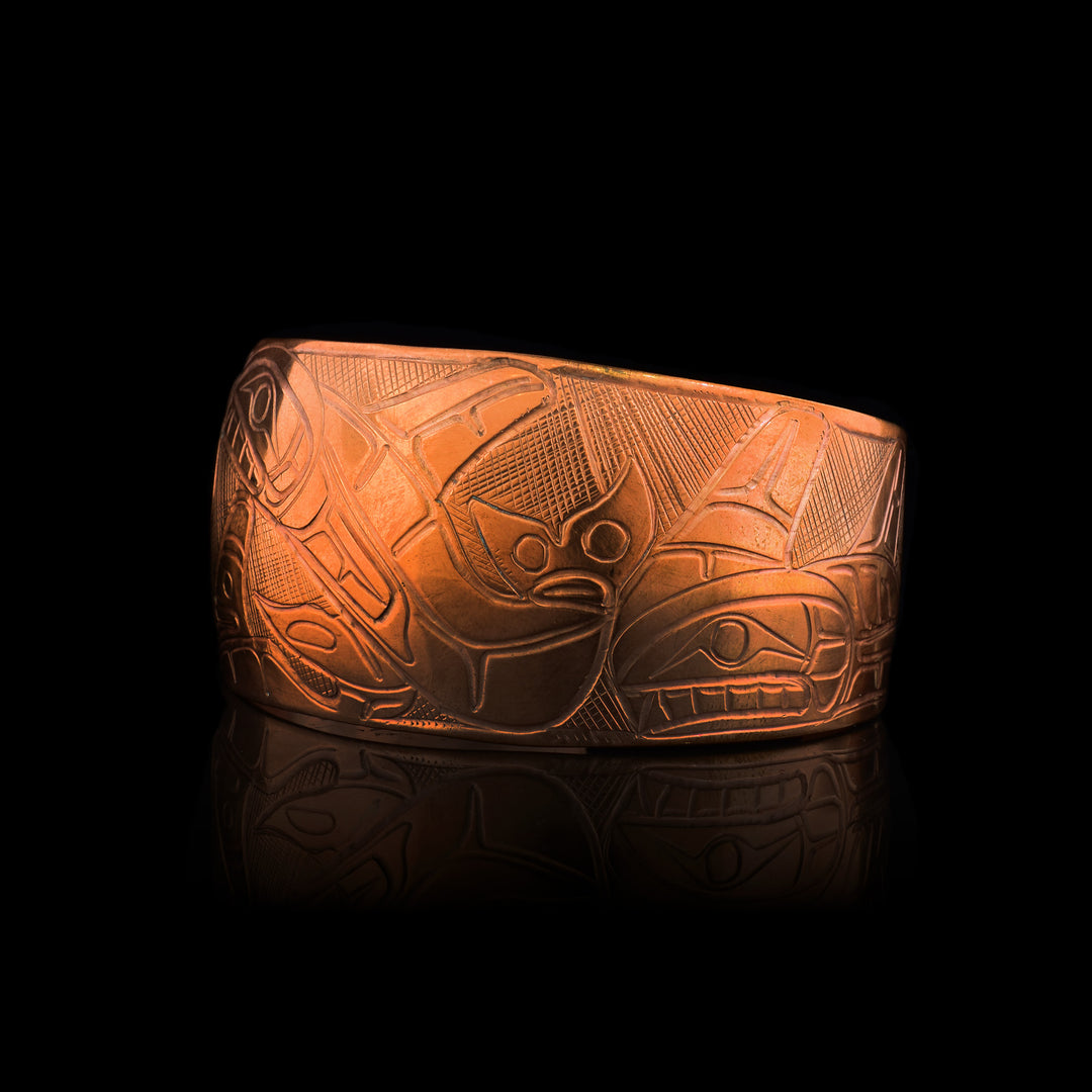 This 1.25" Orca Pod Copper Cuff is carved in the indigenous style with a pod of orcas.