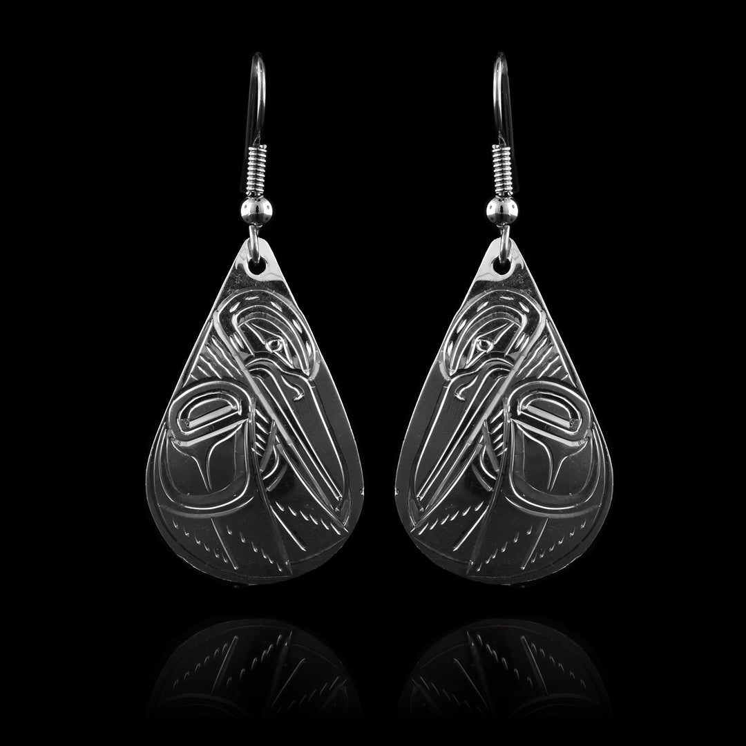 These large teardrop earrings have hangs made from sterling silver that have wide, teardrop shapes. There is a side profile depiction of the Hummingbird on the hangs with its head pointing down and both wings at its side.