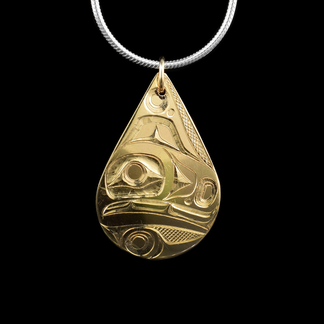 This 14K gold orca pendant is hand-carved with the legend of the orca. The pendant is in the shape of a teardrop.