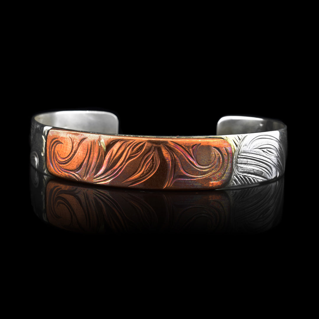 The 1/2" Eagle Orca Moon Sterling Silver Copper Bracelet has been carefully carved, where the eagle and orca are carved into the sterling silver cuff and the moon carved into copper between them. Giving it a three-tiered meaning on a singular piece of jewelry
