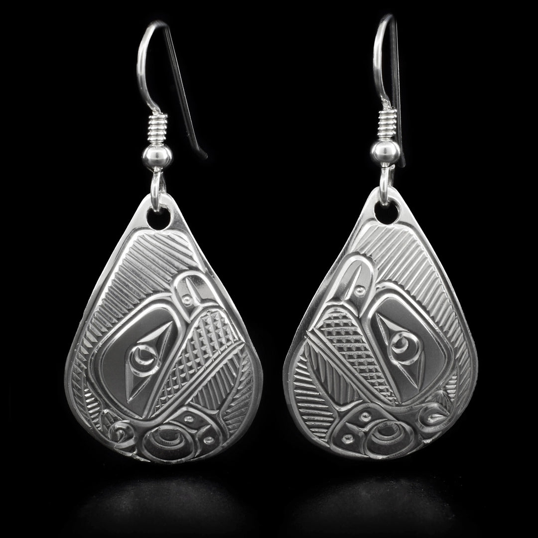 These thunderbird earrings are teardrop in shape and depict the head of a thunderbird with a short, open beak and its wing underneath facing inward.