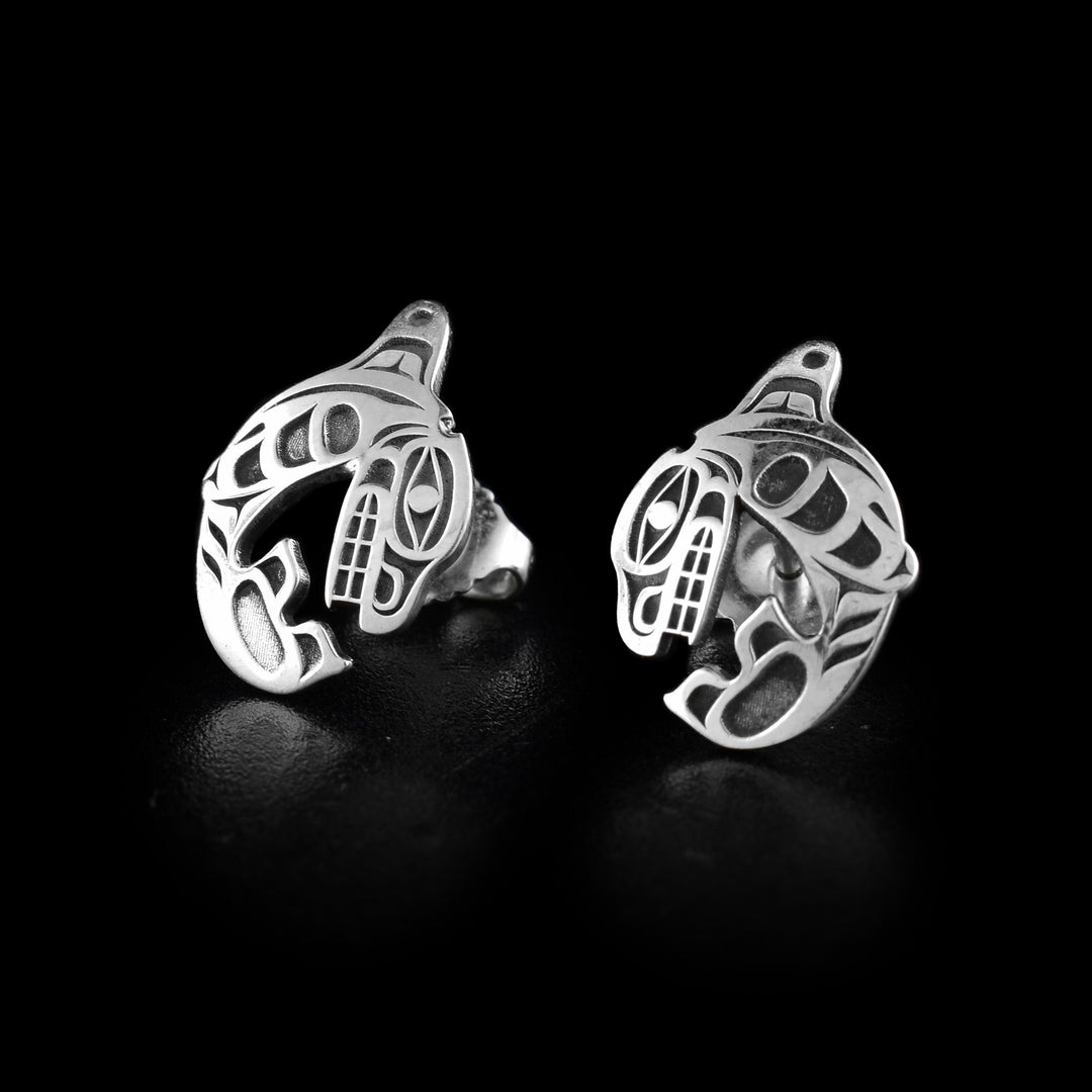These Orca whale stud earrings have been made using sterling silver and are shaped like Orcas that are curled up in a round shape. The head of the Orca curves down and meets the tail and there are details of the Legend cast into the studs.