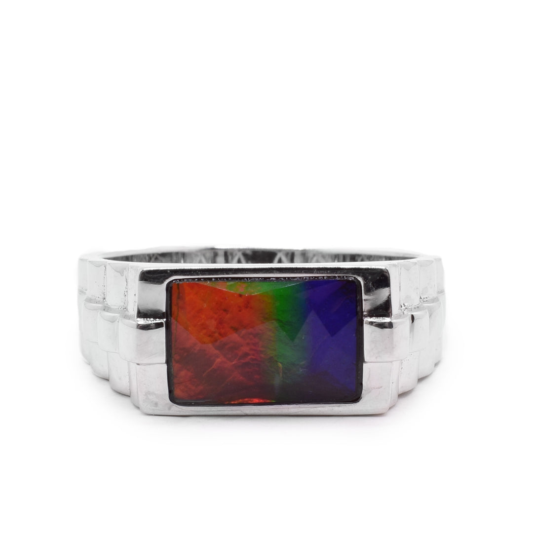 A sterling silver ring with a ribbed band and a rectangular ammolite stone in the middle.