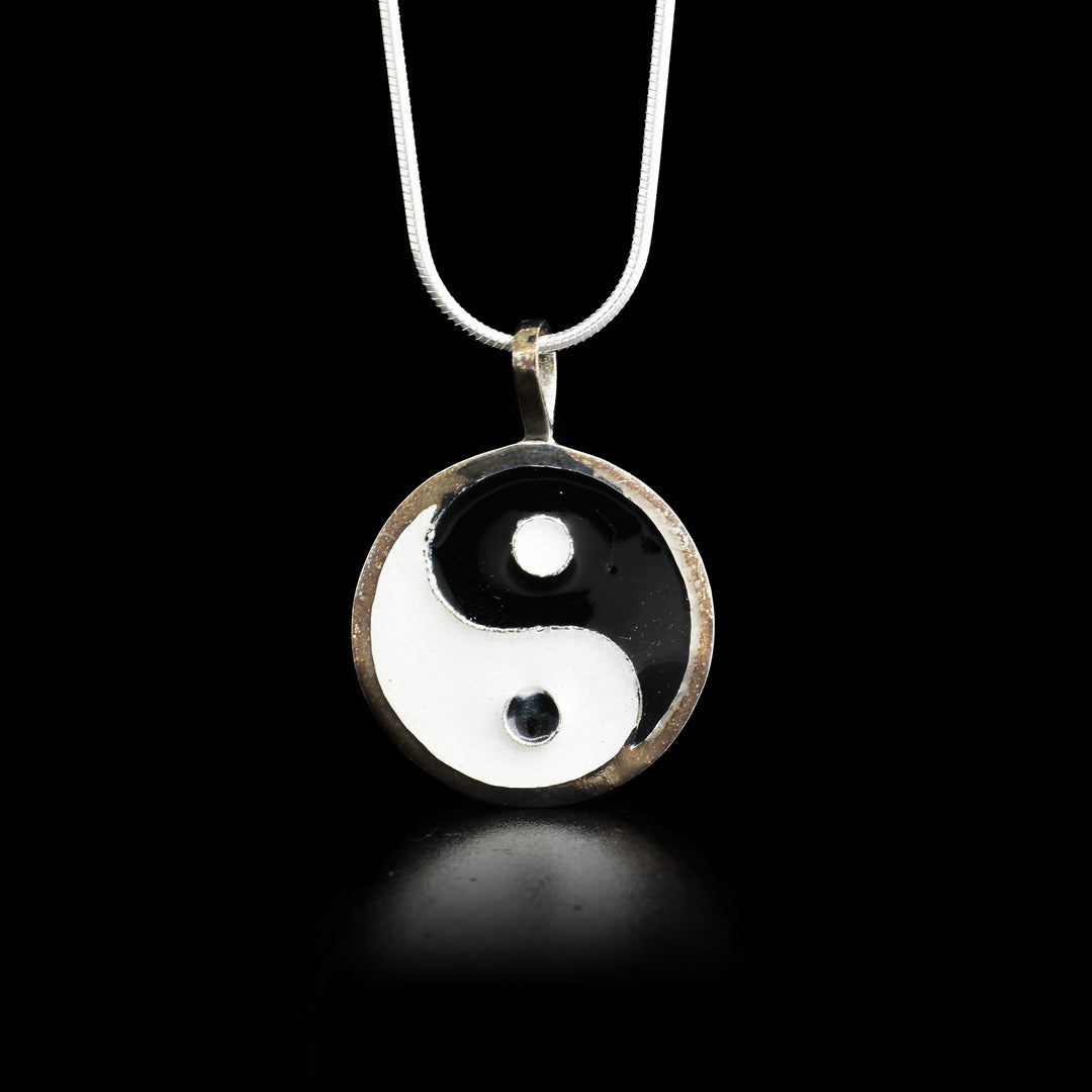 This fine silver and enamel pendant depicts the Chinese symbol Yin Yang.