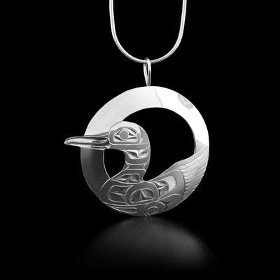 This loon necklace is circular in shape and has a full body loon at the bottom of the pendant. The center of the pendant has been cut out.