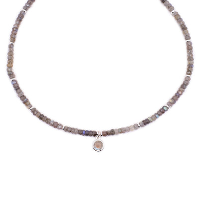 This necklace has small labradorite beads around the entire necklace with one bigger labradorite and sterling silver pendant in the middle. 