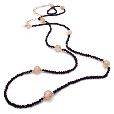 This beaded necklace is made from tiny little black crystals spanning the entirety of the necklace and a few smoky quartz spaced evenly throughout. The chain and accents are gold-filled.