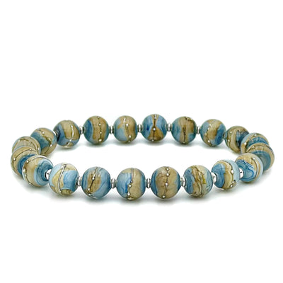 This glass bead bracelet has 20 beads connected on an elastic cord. Each bead is a mixture of light blue, light brown, and scattered white lines and dots.