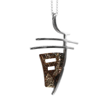 This oxidized silver necklace is an abstract shape with a small oxidized silver rectangle in the center connected to multiple sterling silver lines.