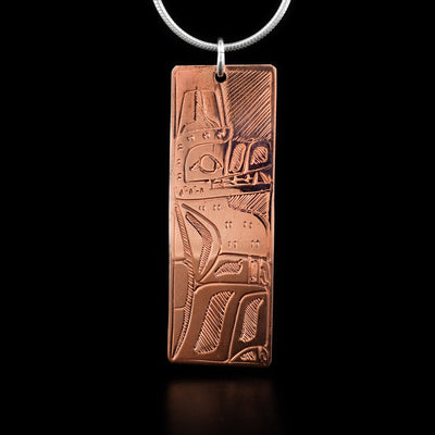 This wolf pendant depicts a full-bodied wolf sitting up and facing the left when worn in the right portion of the pendant. The background has been hatched.