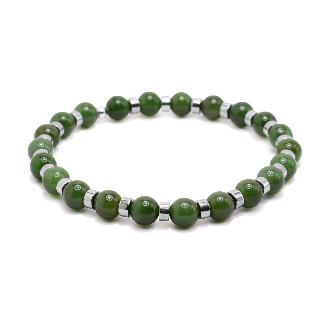 This jade bead bracelet has small, spherical beads made form jade and hematite. there are sterling silver spacers between the beads.