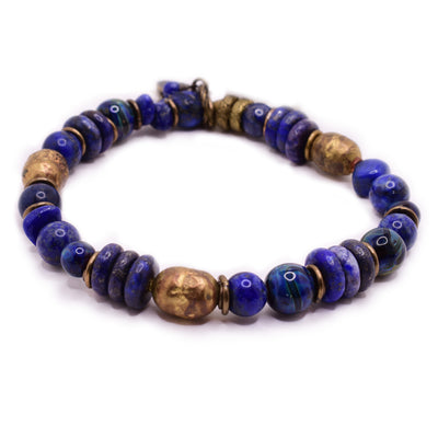 Beaded dark blue stretch bracelet made with brass, lapis lazuli and handmade lampworked glass beads. By artist Wendy Pierson.