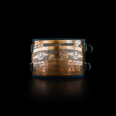This bracelet has a rectangular copper plate that depicts the face of theBear .