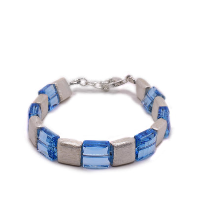 This silver chain bracelet has square blue Swarovski crystal and brushed silver beads. By artist Elizabeth Burry.