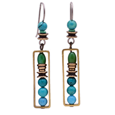 Dangle earrings made of turquoise, magnesite and handworked brass. Titanium ear hooks. By Honica.
