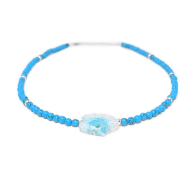Sterling silver beaded necklace with round turquoise beads. Large, central bead is raw blue and white agate.