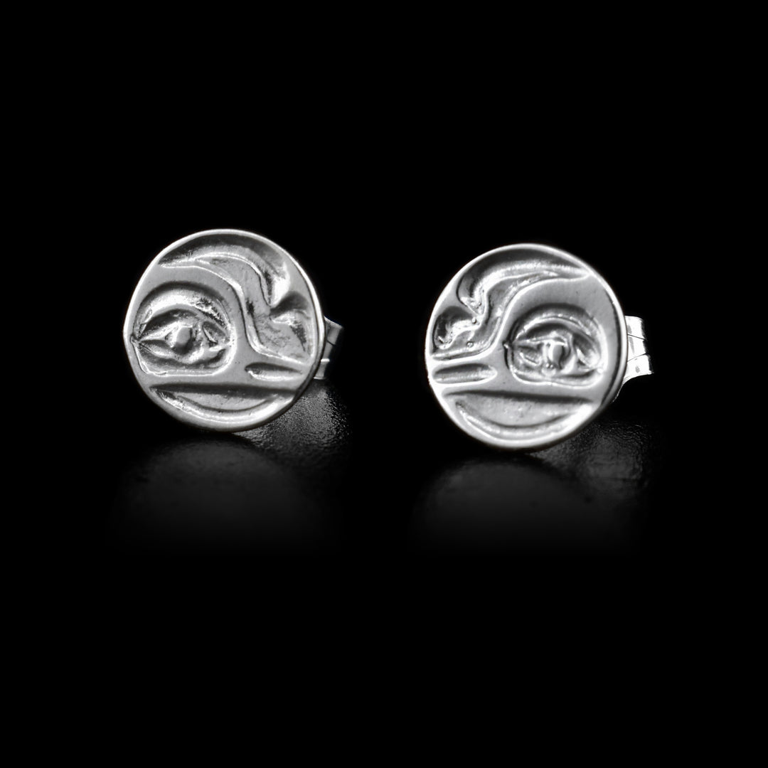 These silver stud earrings are circle shaped and have depictions of the Hummingbird carved into them.