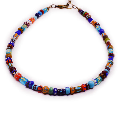 Beaded necklace with handmade lampworked glass beads of different patterns and colours. Brass lobster clasp and extension at back.