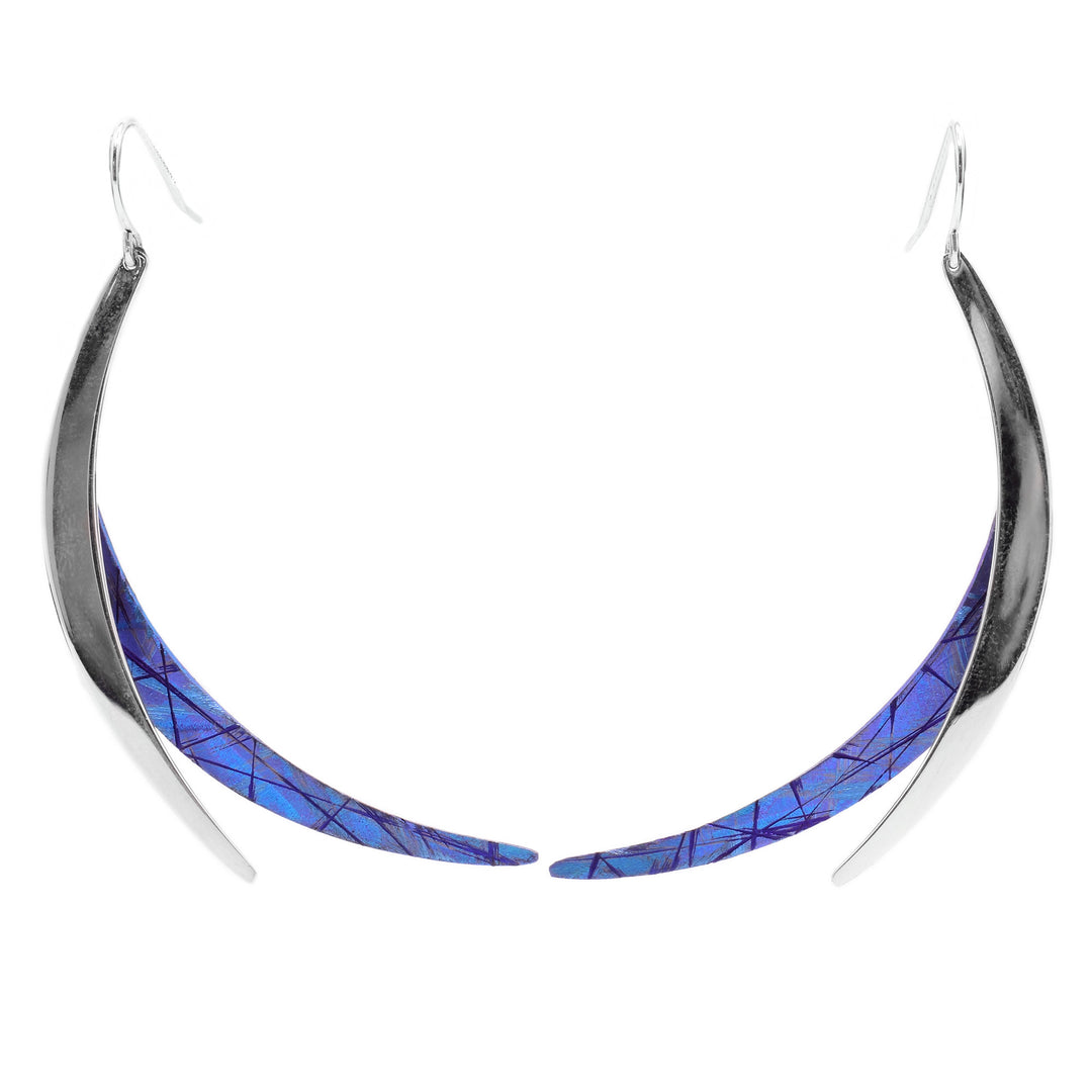 These titanium earrings are in a swooping shape with one part blue anodized titanium and the other sterling silver.