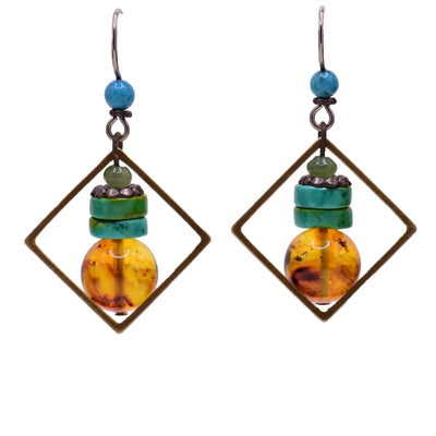Dangle earrings made of handworked brass, turquoise, baltic amber, jade and magnesite. Titanium ear hooks. By Honica.