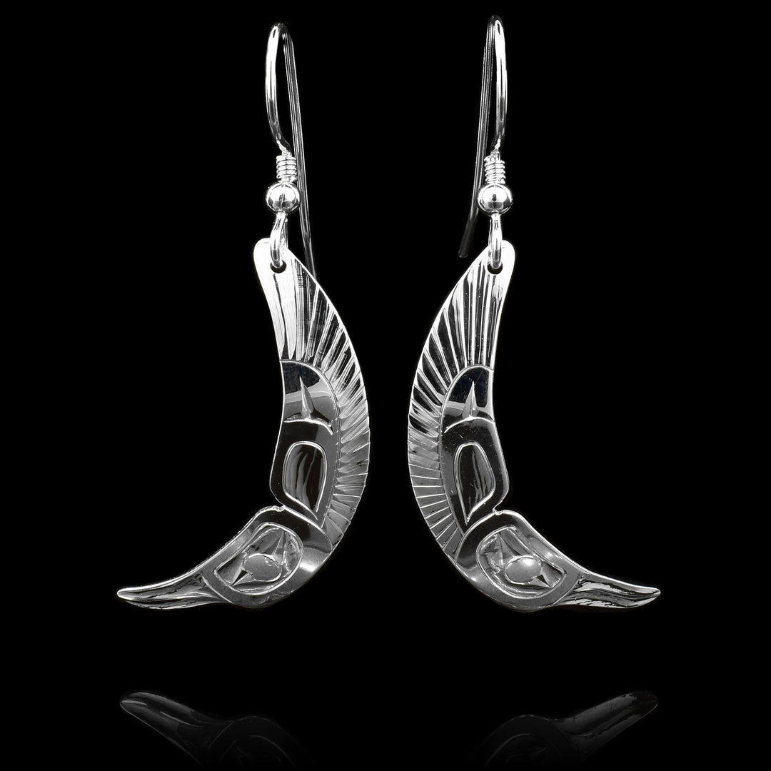 These flying Hummingbird earrings are made from sterling silver have long hangs. There is a depiction of the head of the Hummingbird at the bottom and its wings are curved and extend to the rest of the piece.