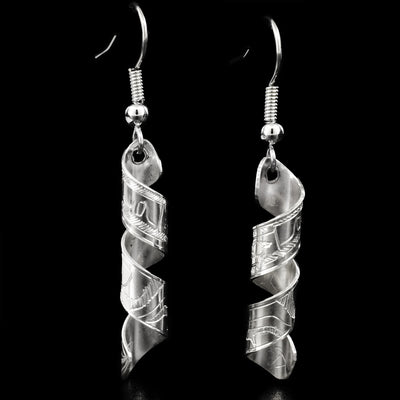 These sterling silver earrings are made out of a flat piece of sterling silver which has the head and body of the Eagle is carved on it. The sterling silver is coiled to create a dainty spiral shape.
