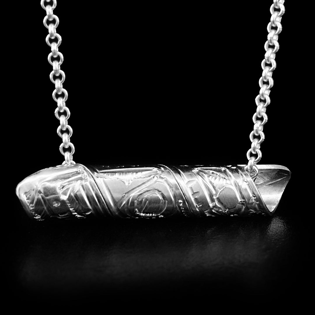 This pendant is made out of a sterling silver strip which has the face and body of the Thunderbird carved on it and then coiled into a spiral.