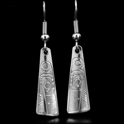 These dangle earrings are made out of sterling silver and are shaped like a long triangle. The Hummingbird is carved at the bottom of the earrings, and is facing downwards.