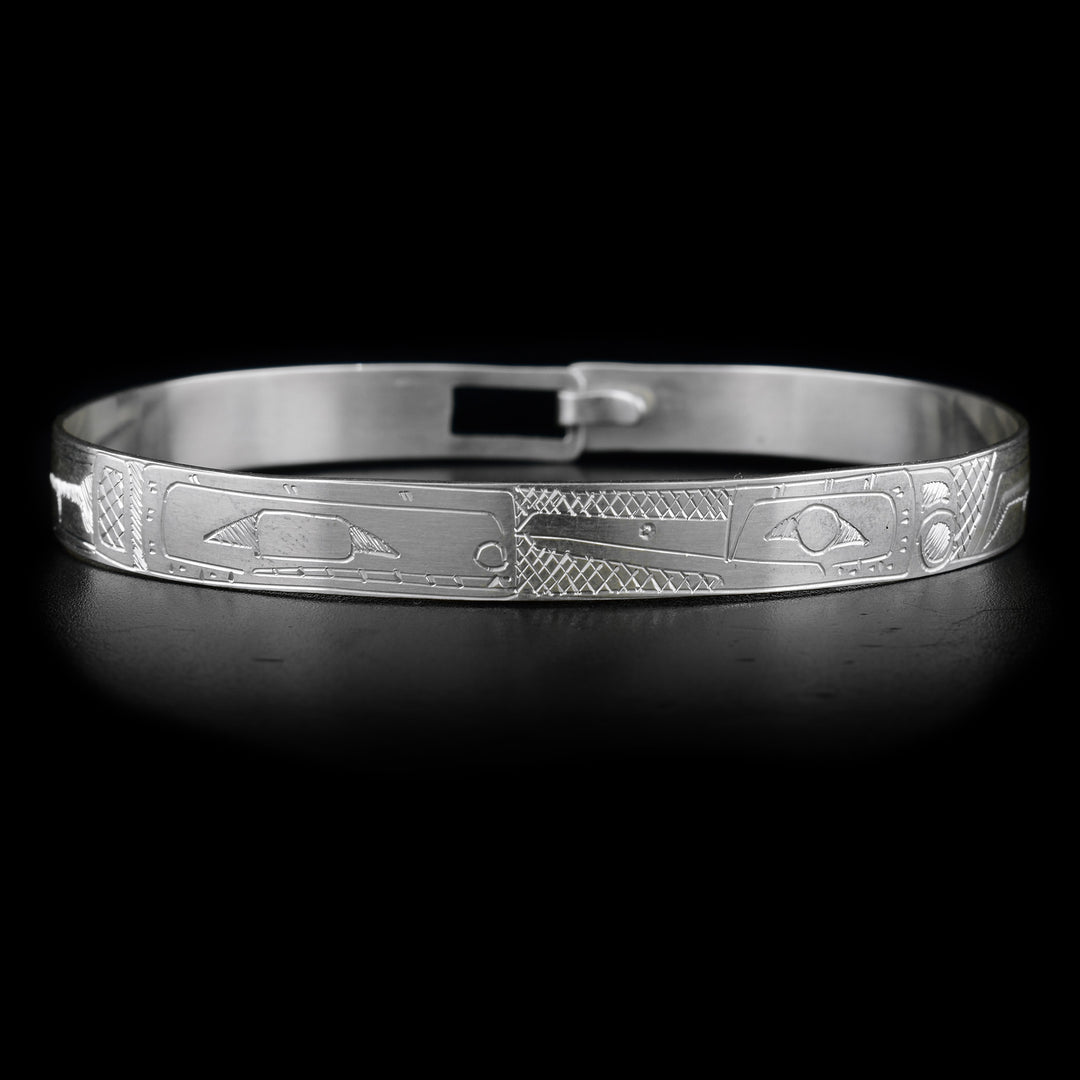 This sterling silver bracelet has the heads of the Orca and the Hummingbird carved on the front, facing each other. Their bodies are engraved on the rest of the bracelet.