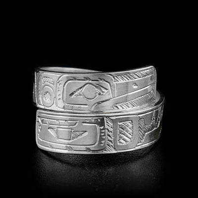 The two ends of this sterling silver wrap ring overlap in the front.One of the ends has an Orca face engraved on it, and the other has a Hummingbird.