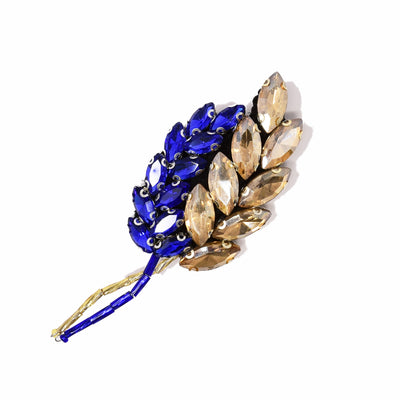 Large brooch featuring dark blue and gold crystal wheat stems intertwining. By Ukrainian guest artist Zarmilka.