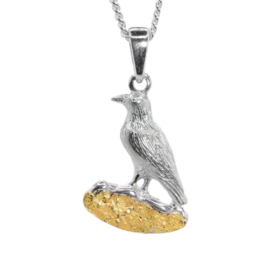 Pendant features sterling silver raven perched atop 22K gold nuggets. Bail is sterling silver. By Tom Gregorczyk.