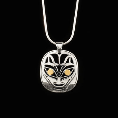 Pendant is pierced and made of sterling silver. Wolf’s pupils are 18K gold. Pendant features view of wolf’s face from the front, paws are at the sides of the face.