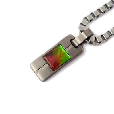 Pendant is a rounded rectangle with an indented line down the middle. A grade ammolite rectangle in middle. Chain is thick and masculine.