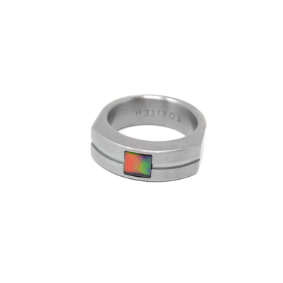 Bulky, masculine grey titanium ring. Top of ring becomes wider and thicker and has indented line across. Top of ring features a square piece of A grade ammolite. Made by Korite International.