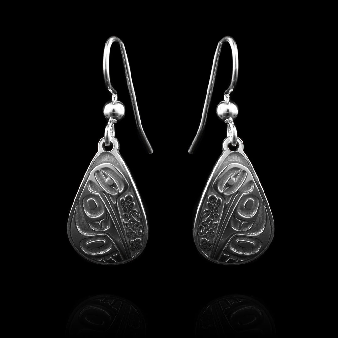 These sterling silver teardrop dangle earrings ae handcarved with the symbol of the hummingbird.