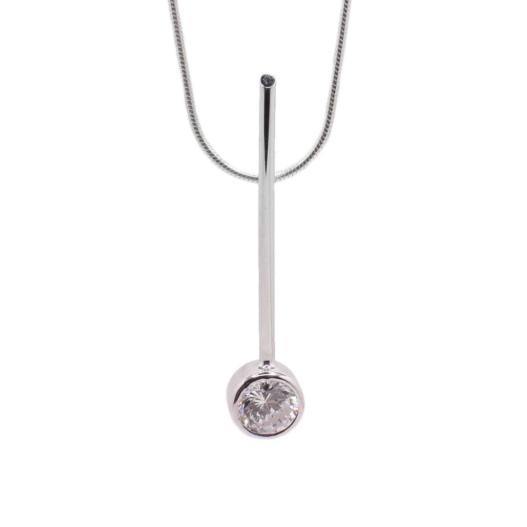 This cubic zirconia necklace is made from sterling silver and has a round chain and a long, thin, and vertical pendant. The pendant has a cubic zirconia gemstone embedded into it at the bottom.