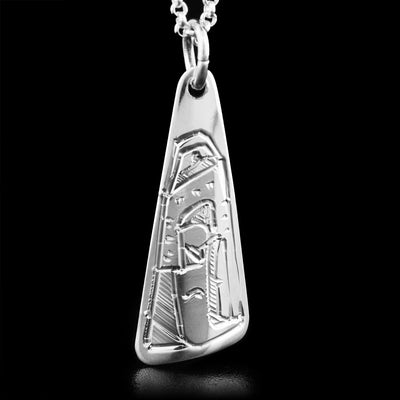 This sterling silver pendant is handcarved in the shape of a triangle. The face of the Eagle is pictured on the pendant, facing downwards.