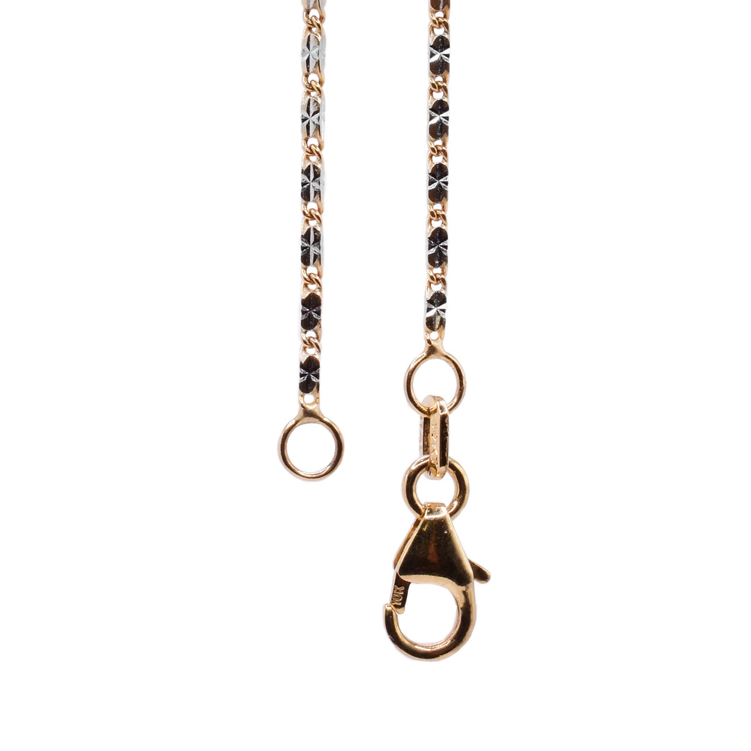 This gold chain necklace has long and thin chain links that have a two tone design achieved by combining 14K yellow gold and 14K white gold.