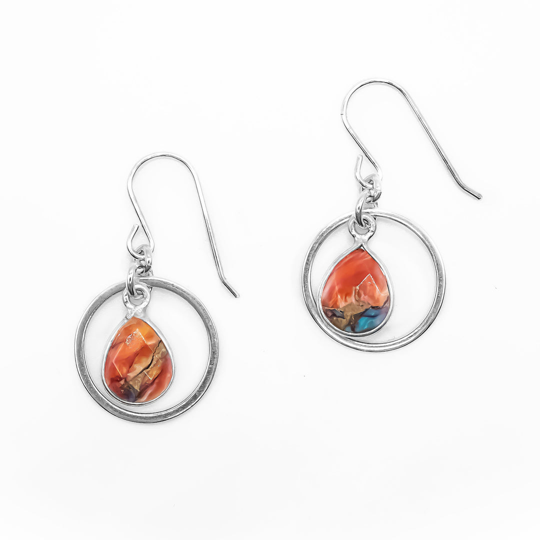 Dangle hoop earrings with flat, faceted oyster shell teardrops dangling in hoops. Metal is sterling silver.