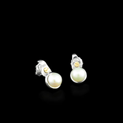 Sterling silver studs with white freshwater mabe pearls and dainty 14K yellow gold bolt adornments above.