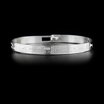 Sterling silver bracelet depicting an orca and a wolf facing each other.