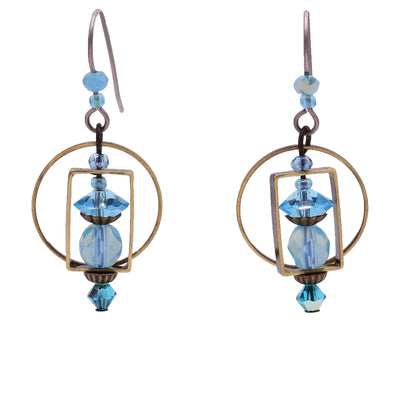Dangle earrings made of Swarovski crystal, handworked brass, and glass. Titanium hooks. By Honica.