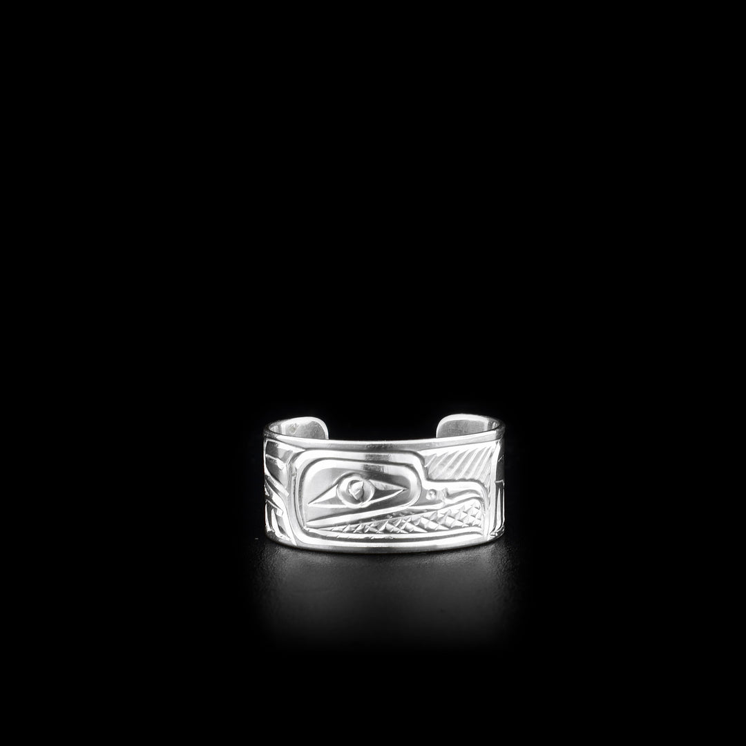 This sterling silver toe ring has a cuff band with a gap in the back. There is a depiction of the Raven that has been carved into the surface of the band.