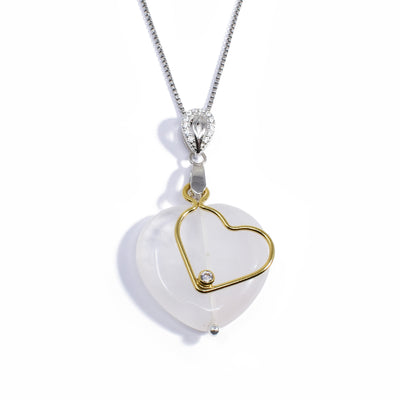 Heart-shaped rose quartz pendant hangs from sterling silver bail with cubic zirconia. Gold-fill wire heart with cubic zirconia in bottom corner hangs in front.