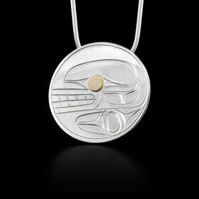 Round, flat pendant featuring orca. 14K yellow gold in eye. Hidden bail on back. Hand-carved by Kwakwaka’wakw artist Paddy Seaweed.