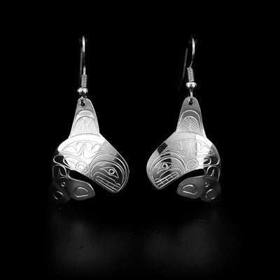 Sterling silver dangle earrings hand-carved by Coast Salish artist Travis Henry. Each earring depicts an orca in a water-breaching movement.