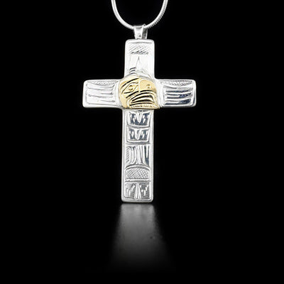 Sterling silver cross pendant featuring eagle with a 14K yellow gold face. By Heiltsuk artist Reg Gladstone.