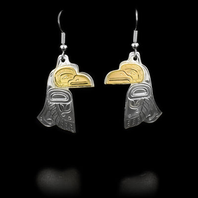 Each dangle earring features a raven with a 14K yellow gold face. Hand-carved by Kwakwaka’wakw artist William Cook.