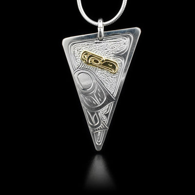 Sterling silver downwards-pointing triangle pendant featuring eagle with 14K yellow gold head. Textured background.